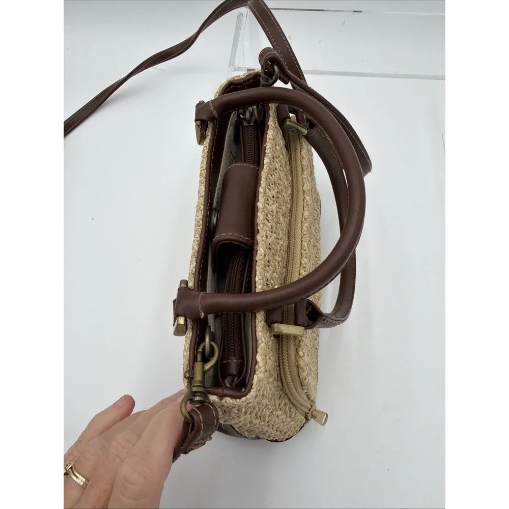 Rosetti straw tote handbag with brown faux leather trim‎ and top handles.